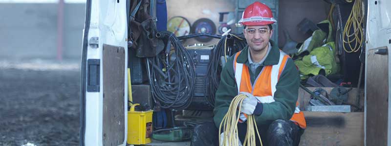 worker supporting ev charging